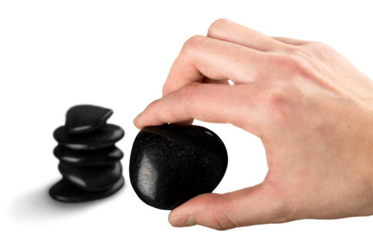 Human hand holds black zen stone - Powered by Adobe