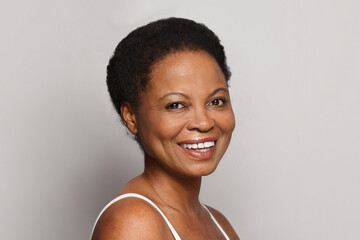 Happy mature model woman with cute smile. Cosmetology, facial treatment and skin care concept