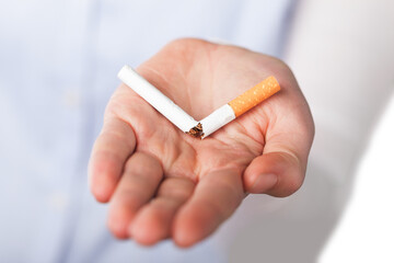 A woman breaking a cigarette, Stop smoking concept