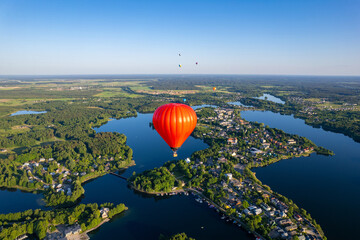 Aerial summer sunny sunset view of Trakai Island Castle and hot air balloons, Lithuania