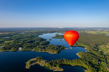 Aerial summer sunny sunset view of hot air balloon over Galve lake, Lithuania