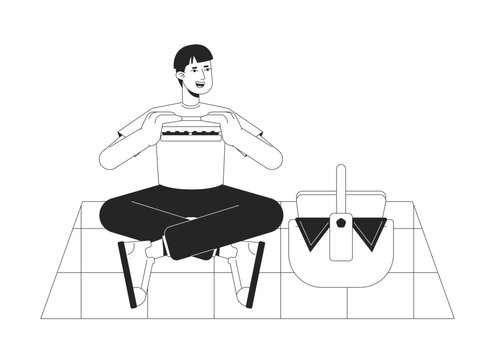 Guy eating sandwich on summer picnic bw vector spot illustration. Happy man with picnic basket 2D cartoon flat line monochromatic character for web UI design. Editable isolated outline hero image