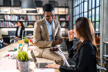 Group of creative asian business meeting and discussing strategy startup project analysis finance process.Success business people work plan and brainstorm marketing idea with laptop in office.Teamwork