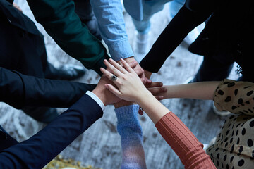 A top view photo of group of businessmen holding hands together to symbolize unity and strength