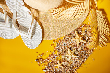 Flat lay Beach accessorie white flip flop and beach hat, seashell,  palm on yellow background,...