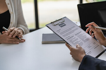 Executive reading resume during job interview and businessman filling in application form Concept of successful hiring and recruitment of human resources.