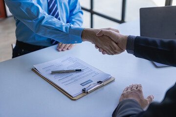 handshake during job interview Male candidate shaking hands with interviewer or employer after job interview Hiring and recruiting in the office