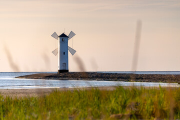Panoramic image of an old lighthouse in Swinoujscie, a port in Poland on the Baltic Sea. - obrazy, fototapety, plakaty