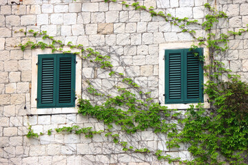 Fototapeta na wymiar Picturesque windows on traditional old Mediterranean house in Split, Croatia.