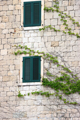Picturesque windows on traditional old Mediterranean house in Split, Croatia.