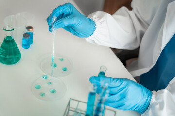 Female scientist researcher conducting an experiment working in the chemical laboratory.