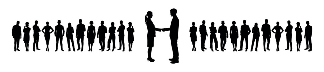 Businessman and businesswoman shaking hands standing in front of large group of business people silhouettes.