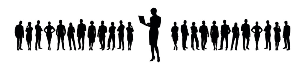 Businesswoman working with laptop while standing in front of large group of business people silhouette.