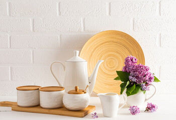 Modern stylish kitchen background in white tones with eco-friendly various utensils and utensils against the background of a white brick wall.