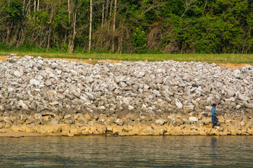fishing on the edge of a river