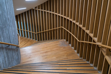 Staircase with wooden paneled wall