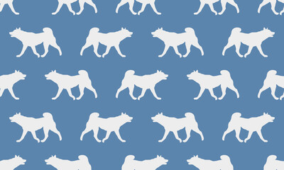 Fototapeta premium Dog silhouette. Walking american akita puppy isolated on a blue background. Seamless pattern. Endless texture. Design for wallpaper, fabric, template, printing. Vector illustration.