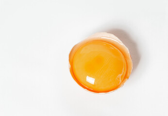 broken chicken raw egg on a light background close-up.