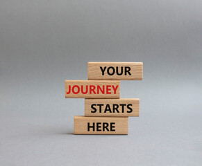 Your Journey starts here symbol. Concept word. Your Journey starts here on wooden blocks. Beautiful grey background. Business and Your Journey starts here concept. Copy space