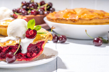 Homemade sweet cherry cake with vanilla ice cream ball. Slice of cherry pie topped with scoop of melting ice cream