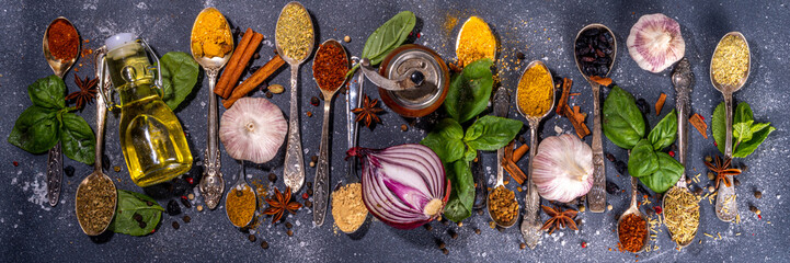 Spices for cooking on dark background . Different seasonings, spices and herbs paprika, pepper,...