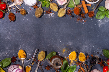 Spices for cooking on dark background . Different seasonings, spices and herbs paprika, pepper, turmeric, salt, basil, mint, cinnamon, garlic and other aromatic ingredients for preparation food