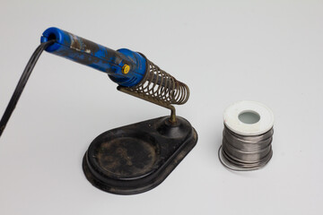 Solder for soldering with a soldering iron in a Bay on a white background.