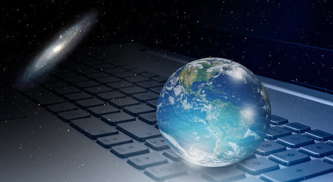 Glass globe on laptop keyboard with Andromeda galaxy "Elements of this image furnished by NASA "