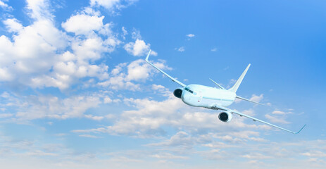 White passenger airplane flying in the sky amazing clouds in the background - Travel by air transport