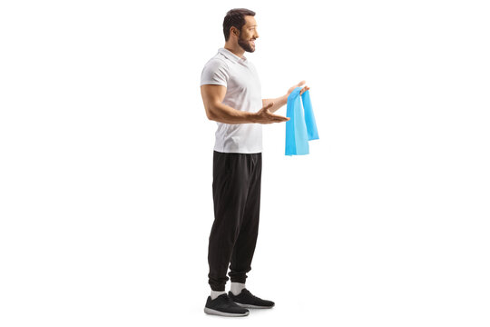 Full length profile shot of a fitness coach holding an exercise resistance band