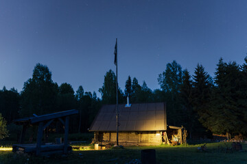 Estonian farm in the forest at night in summer.