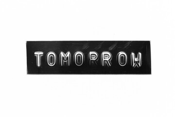 Black color banner that have embossed letter with word tomorrow on white paper background