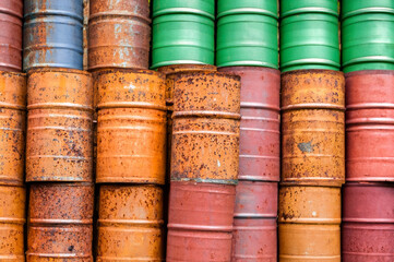 dented rusty colorful barrels