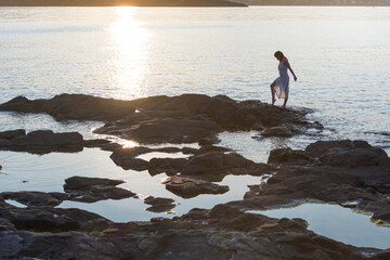 woman working with a tablet at home beautiful window light cozy, smiling looking at camera, showing camera, plants