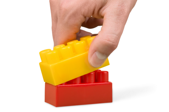 Hand Playing with Toy Blocks