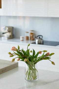 Vertical image of beautiful flowers in vase in modern kitchen
