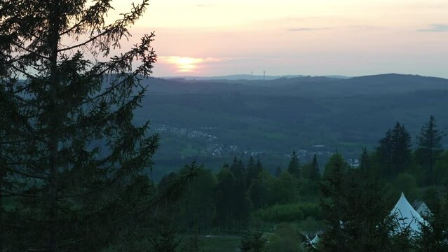 sunset over the mountain range of the Rothaargsteig close to Luetzel in Germany.
