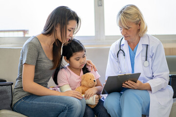 Fototapeta premium Pediatrician is closely caring and asking about sick girls symptoms, health concepts and child care.