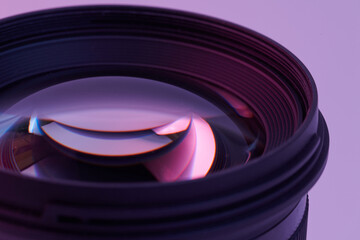 camera lens closeup isolated on white background in pink lilac neon light