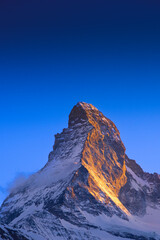 The famous mountain Matterhorn peak orange sunray on mountain with clear blue sky from Gornergrat, Zermatt, Switzerland