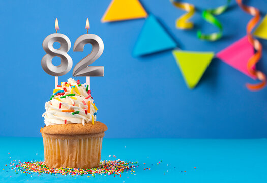 Birthday cake with candle number 82 - Blue background