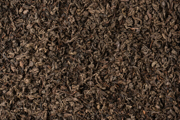 Dried tea leaves as a background.