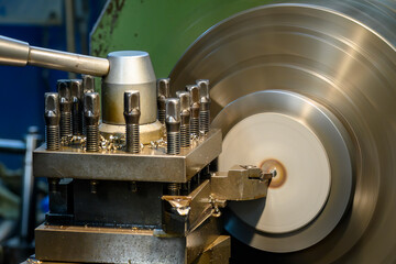 Closeup scene the lathe machine finish cut the brass parts by lathe tools.