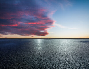 Asphalt road and colorful sky clouds background