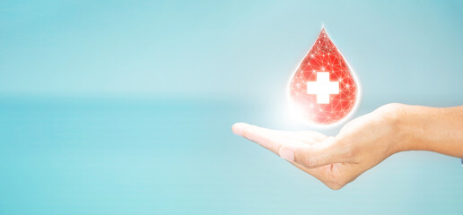 hand hold glowing red drop for world blood donor day , healthcare, medicine and blood donation concept  