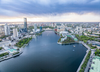 Fototapeta premium Yekaterinburg city and pond aerial panoramic view at summer sunset.