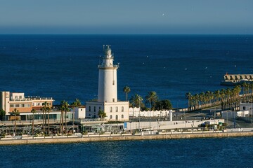 Fototapeta na wymiar MALAGA, SPAIN - March 08, 2023. Lighthouse Farola in Malaga port
