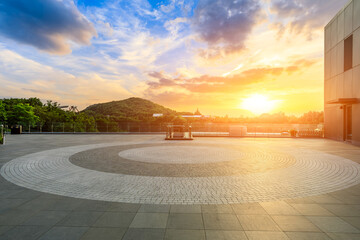 Empty square floor and green mountain with beautiful sky clouds at sunset