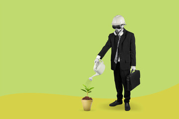 Businessman wearing a gas mask watering plant in pot with can