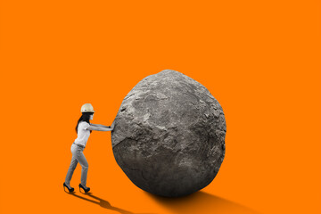 Female engineer with safety helmet pushing big rock